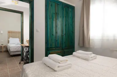 a bedroom with two white towels on a bed at Oniro Beach House in Archangelos