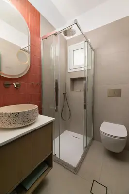 a bathroom with a shower with a toilet and a sink at Oniro Beach House in Archangelos
