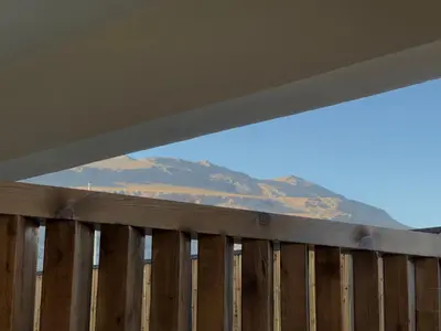 a wooden fence with a mountain in the background at Yucca Calma in Líndos