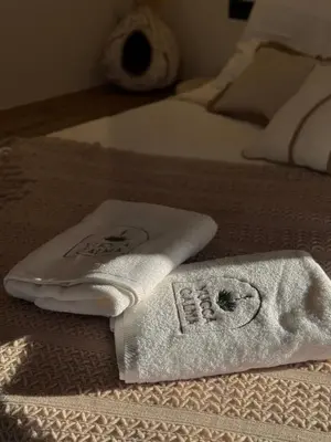 a pair of towels sitting on top of a bed at Yucca Calma in Líndos
