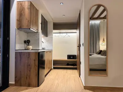 a kitchen with a large mirror next to a bedroom at Yucca Calma in Líndos