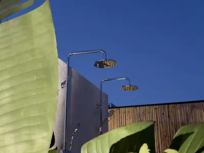 two lights on a wall with green leaves at Yucca Calma in Líndos