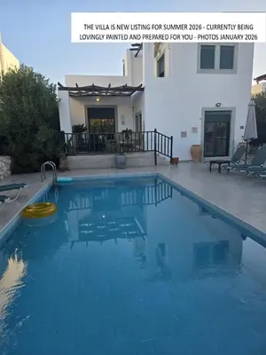 a large blue swimming pool in front of a house at 2 Bedroom Villa with Pool Pylona Gardens close to Lindos in vlicha