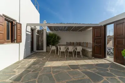 a patio with chairs and a table in a house at Lindos 4 me Villa in Líndos