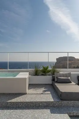 a balcony with a view of the ocean at Lindos 4 me Villa in Líndos