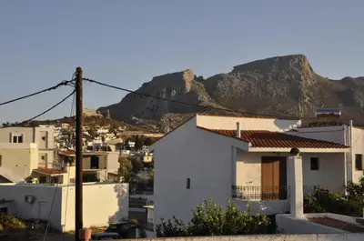 a view of a city with mountains in the background at Pension Annoula in Archangelos