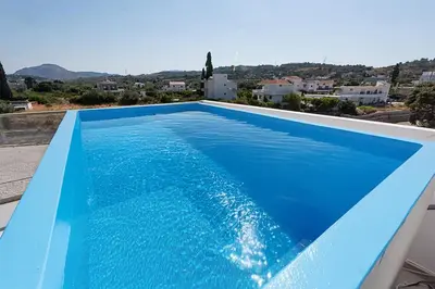a blue swimming pool on the roof of a house at Sinani Villas Rhodes in Afantou