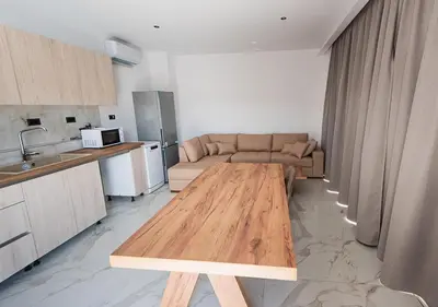 a living room with a couch and a wooden table at Sinani Villas Rhodes in Afantou