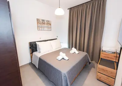 a bedroom with a bed with two towels on it at Sinani Villas Rhodes in Afantou