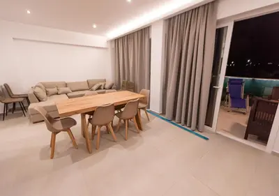 a dining room with a wooden table and chairs at Sinani Villas Rhodes in Afantou