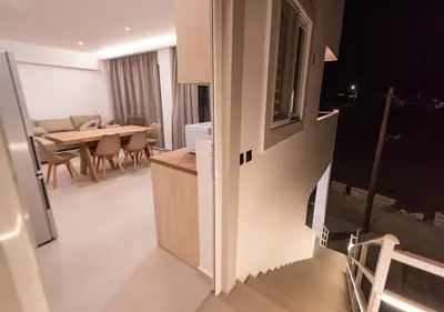a kitchen and dining room with a table and chairs at Sinani Villas Rhodes in Afantou