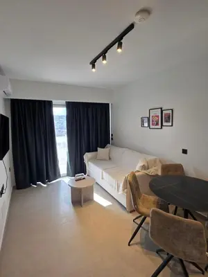 a bedroom with a bed and a table at Casa Bronx luxury apartment in Rhodes Town