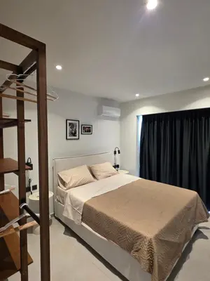 a bedroom with a large bed and a window at Casa Bronx luxury apartment in Rhodes Town