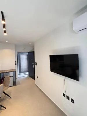 a living room with a flat screen tv on a wall at Casa Bronx luxury apartment in Rhodes Town