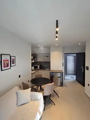 a room with a bed and a table and a kitchen at Casa Bronx luxury apartment in Rhodes Town