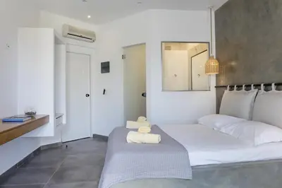 a bedroom with a bed with towels on it at Hercules Plus in Faliraki