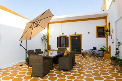 a room with a table and chairs and an umbrella at Villa Savastoula in Phanaes