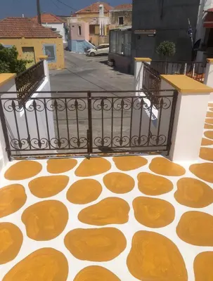 a balcony with a patterned floor and a railing at Villa Savastoula in Phanaes