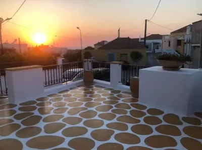 a view of a balcony with a sunset in the background at Villa Savastoula in Phanaes