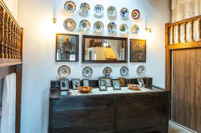 a room with a table with plates on the wall at Villa Savastoula in Phanaes