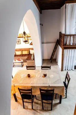 a dining room with a table and chairs at Villa Savastoula in Phanaes