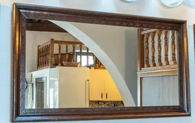 a mirror with a reflection of a staircase in a room at Villa Savastoula in Phanaes