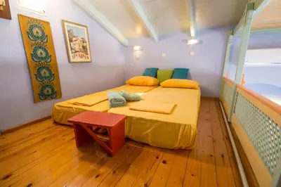 a small room with two beds and a table at Symi Traditional Appartment in Symi