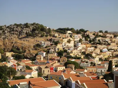 a town on a hill with houses at Symi Traditional Appartment in Symi
