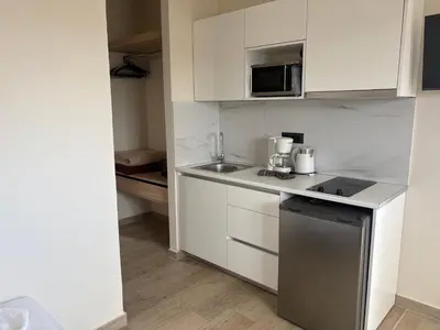 a small kitchen with a sink and a microwave at Barbie II in Ialyssos