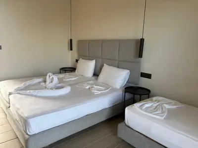 a bedroom with two beds with towels on them at Barbie II in Ialyssos