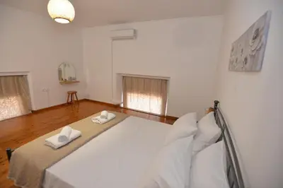a bedroom with a large bed with two towels on it at Sotirias House in Rhodes Town