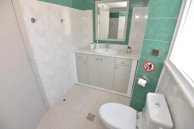 a bathroom with a toilet and a sink and a mirror at Sotirias House in Rhodes Town