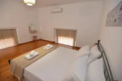 a bedroom with a large bed with two towels on it at Sotirias House in Rhodes Town
