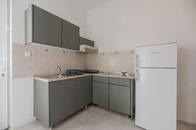a kitchen with a sink and a refrigerator at Rhodes Archaggelos Nests - Fully Equipped Getaways in Archangelos