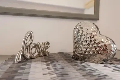 a silver heart and the word love on a table at Rhodes Archaggelos Nests - Fully Equipped Getaways in Archangelos