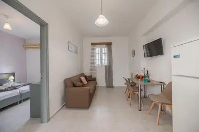 a living room with a couch and a table at Rhodes Archaggelos Nests - Fully Equipped Getaways in Archangelos