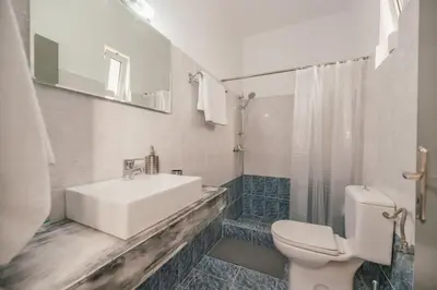a bathroom with a sink and a toilet and a shower at Rhodes Archaggelos Nests - Fully Equipped Getaways in Archangelos