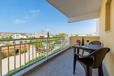 a balcony with a table and chairs and a view at Rhodes Archaggelos Nests - Fully Equipped Getaways in Archangelos