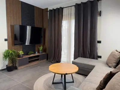 a living room with a couch and a table at Kálos Housing - Adults Only in Kolimbia