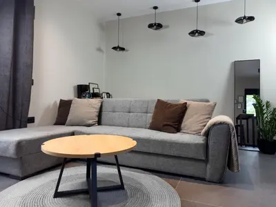 a living room with a couch and a table at Kálos Housing - Adults Only in Kolimbia