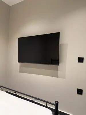 a flat screen tv hanging on a wall at Kálos Housing - Adults Only in Kolimbia