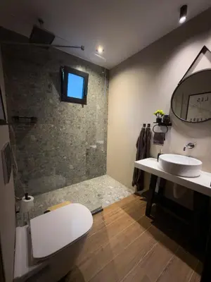 a bathroom with a toilet and a sink and a shower at Kálos Housing - Adults Only in Kolimbia