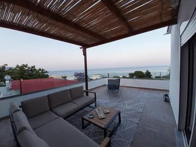 a living room with a couch and a table at Little Paradis in Archangelos