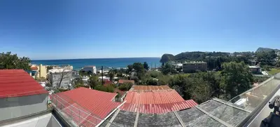 an aerial view of a city with the ocean at Little Paradis in Archangelos
