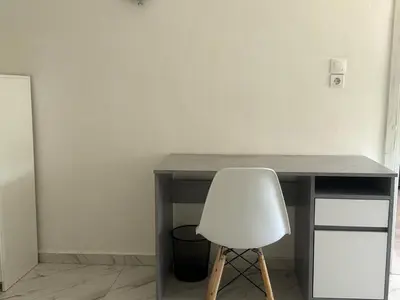 a white chair sitting in front of a desk at Little Paradis in Archangelos