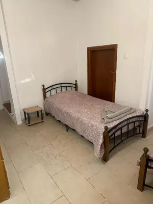 a bedroom with a bed and a wooden door at Little Paradis in Archangelos