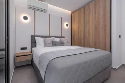a bedroom with a large bed and a wooden wall at Luxury Villa Amani Retreat in Líndos
