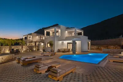 a villa with a swimming pool at night at Luxury Villa Amani Retreat in Líndos