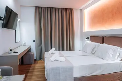 a hotel room with a bed with towels on it at ILIADA Boutique Rooms in Faliraki