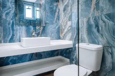 a bathroom with a toilet and a sink and a mirror at ILIADA Boutique Rooms in Faliraki